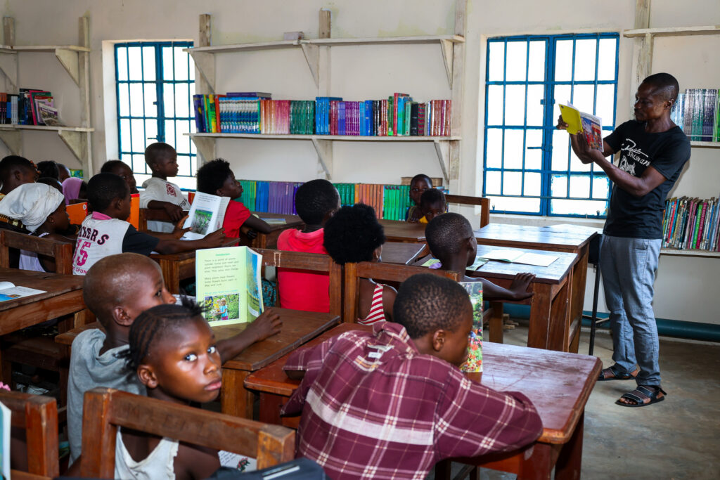 Librarian Umaru Kpaka reading to kids at the library on a Saturday morning